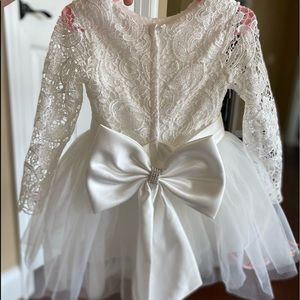 Long sleeve lace and tulle flower girl dress with satin bow in the back. Size 2t